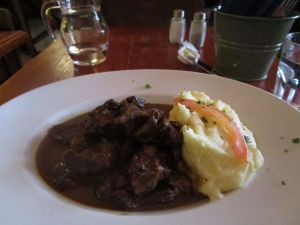 Mashed potatoes and meat in gravy with bread - Brussels