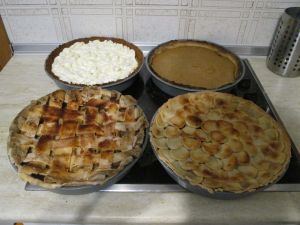 Thanksgiving pies from back left corner going clockwise: Pumpkin Banana Mousse Tart, Pumpkin Pie, Pear Cranberry Pie, & Apple Pie