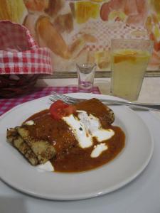 Salty crepe stuffed with meat in paprika sauce and a glass of homemade lemonade - Budapest